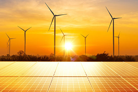solar panels with windmills in background